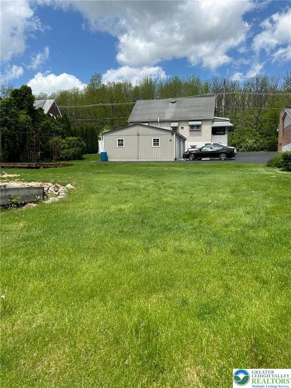 424 West Main Street Bath, PA 18014 - Photo 20 of 30 a car parked in the grass near a building