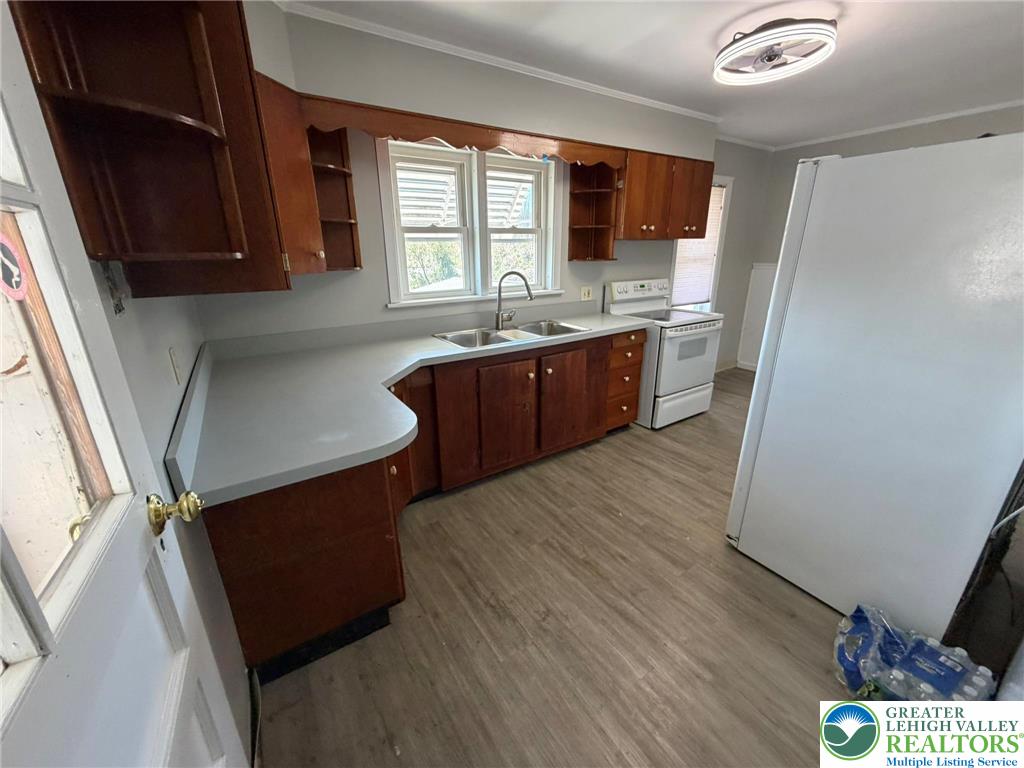 424 West Main Street Bath, PA 18014 - Photo 10 of 30 a kitchen with stainless steel appliances granite countertop a refrigerator a sink dishwasher a stove a microwave oven and a dining table with wooden floor