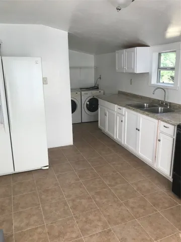 a kitchen with a sink a stove and refrigerator