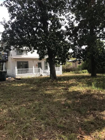 a front view of a house with a yard garage and tree