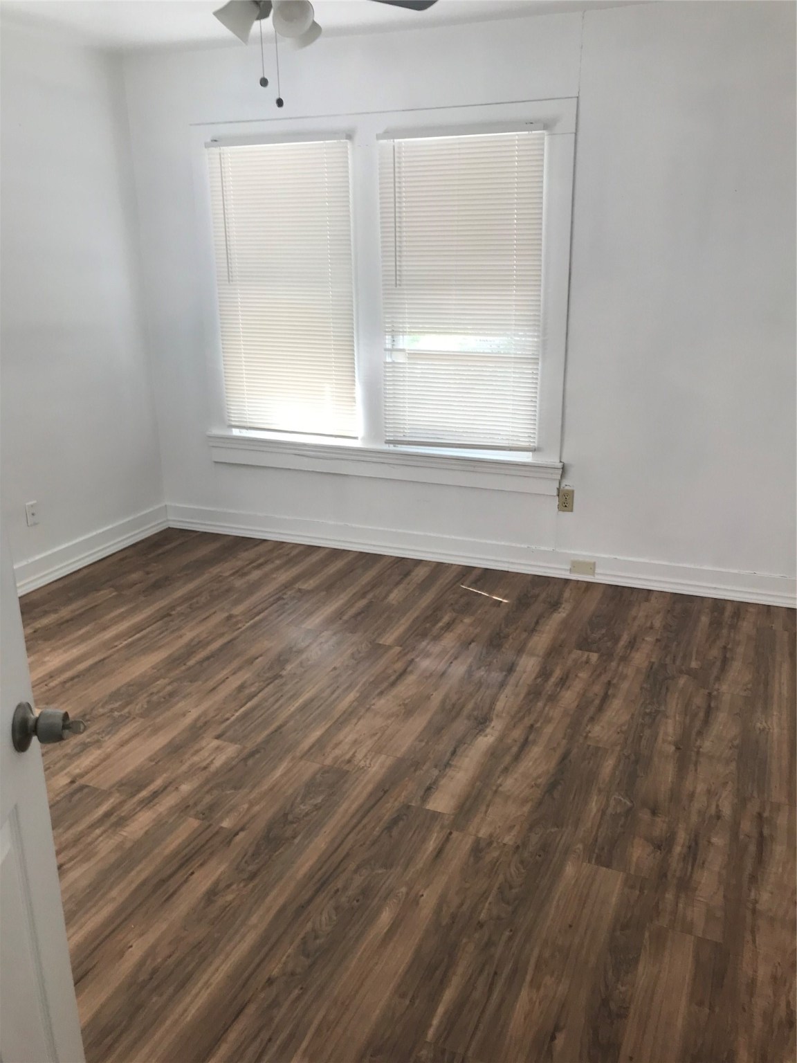 2909 Sam Houston Avenue Huntsville, TX 77340 - Photo 3 of 16 an empty room with wooden floor and windows
