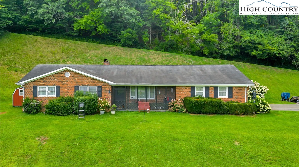 a view of a house with garden and yard