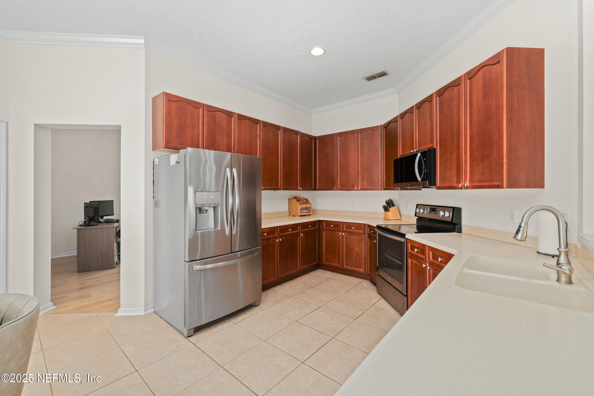 1256 Splendid Ravine Street St. Augustine, FL 32092 - Photo 2 of 36 a kitchen with stainless steel appliances granite countertop a refrigerator and a sink