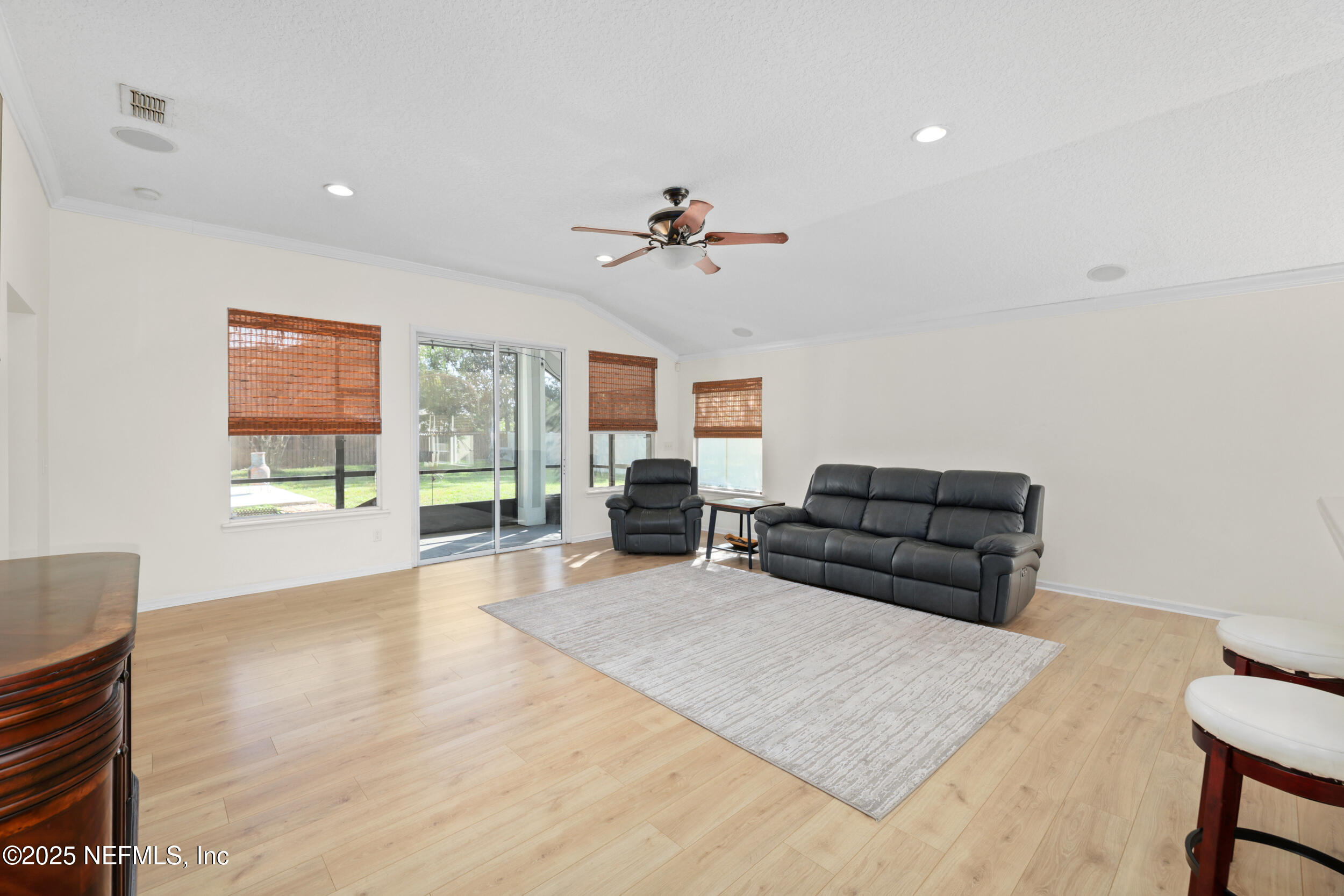 1256 Splendid Ravine Street St. Augustine, FL 32092 - Photo 7 of 36 a living room with furniture ceiling fan and a window