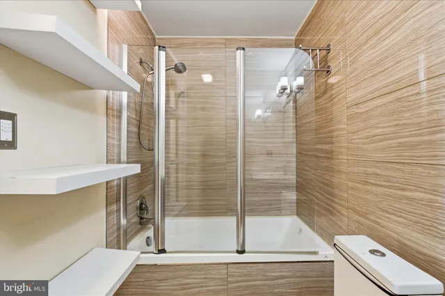 a bathroom with a shower and a toilet