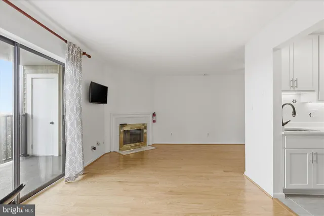 a view of kitchen with sink cabinet and natural light
