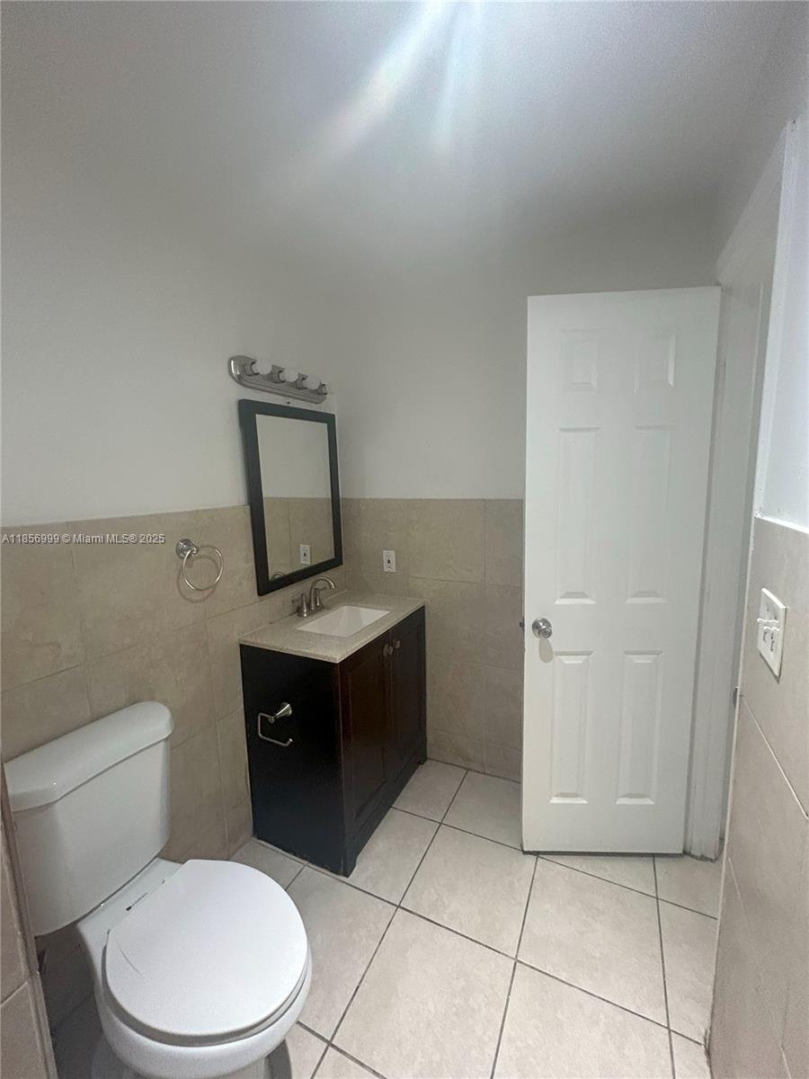 3876 Northwest 207 St Road, Unit 3876 Miami Gardens, FL 33055 - Photo 11 of 22 a bathroom with a toilet sink and mirror