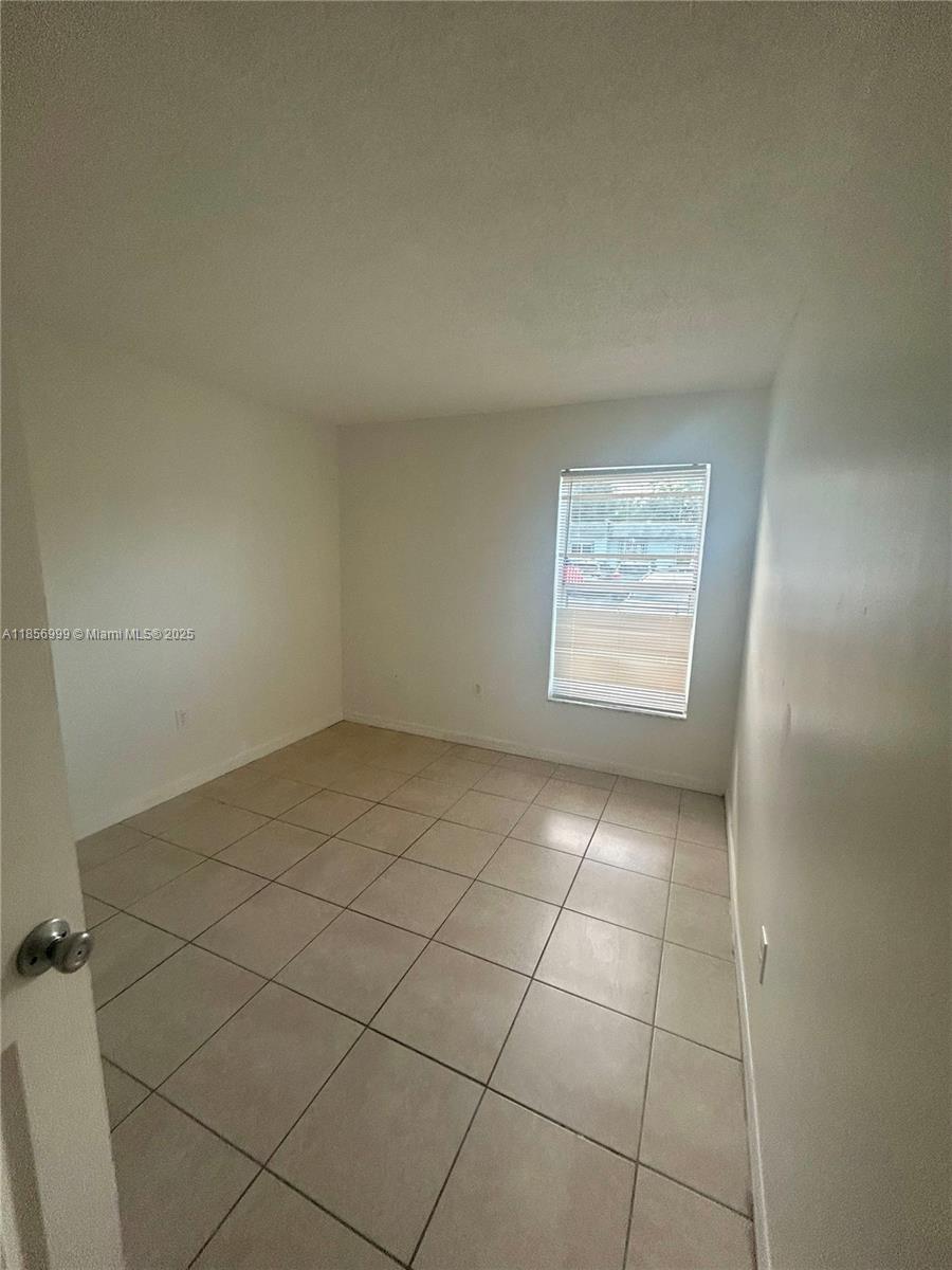 3876 Northwest 207 St Road, Unit 3876 Miami Gardens, FL 33055 - Photo 17 of 22 a view of an empty room and a window