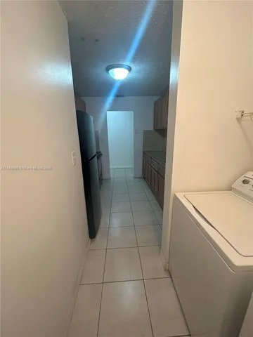 a hallway with washer and dryer