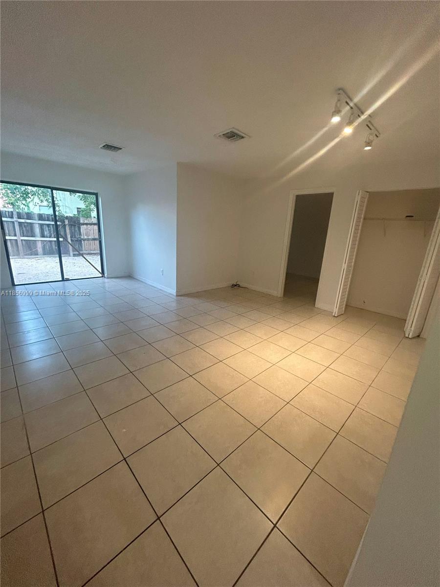 3876 Northwest 207 St Road, Unit 3876 Miami Gardens, FL 33055 - Photo 7 of 22 a view of a livingroom and window