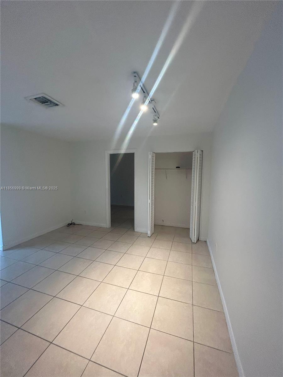 3876 Northwest 207 St Road, Unit 3876 Miami Gardens, FL 33055 - Photo 8 of 22 a view of an empty room with a window