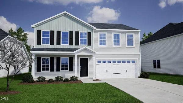 a front view of a house with a garden and yard