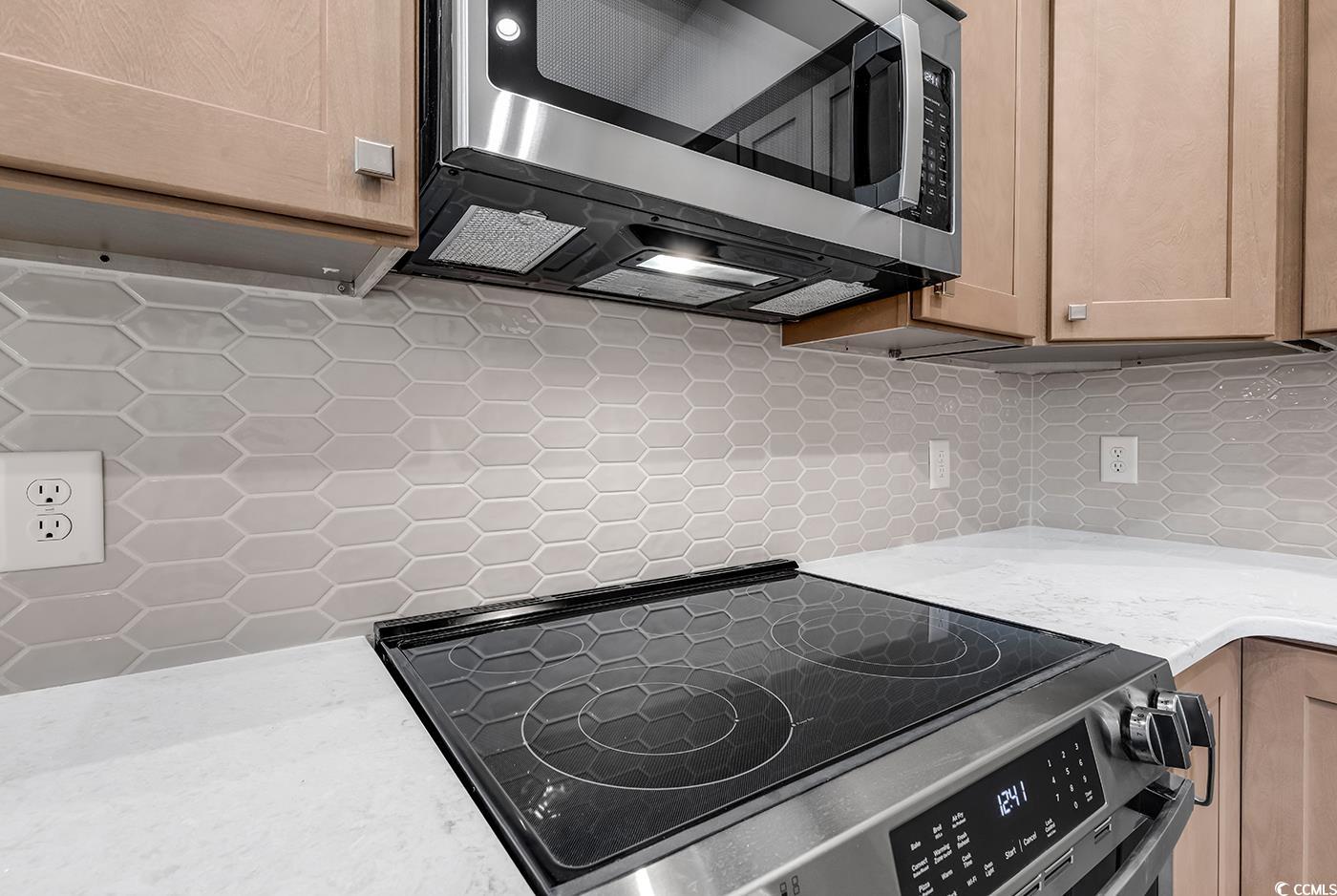 718 Highway 348 Loris, SC 29569 - Photo 16 of 28 Decorative tile backsplash, electric range, vented microwave