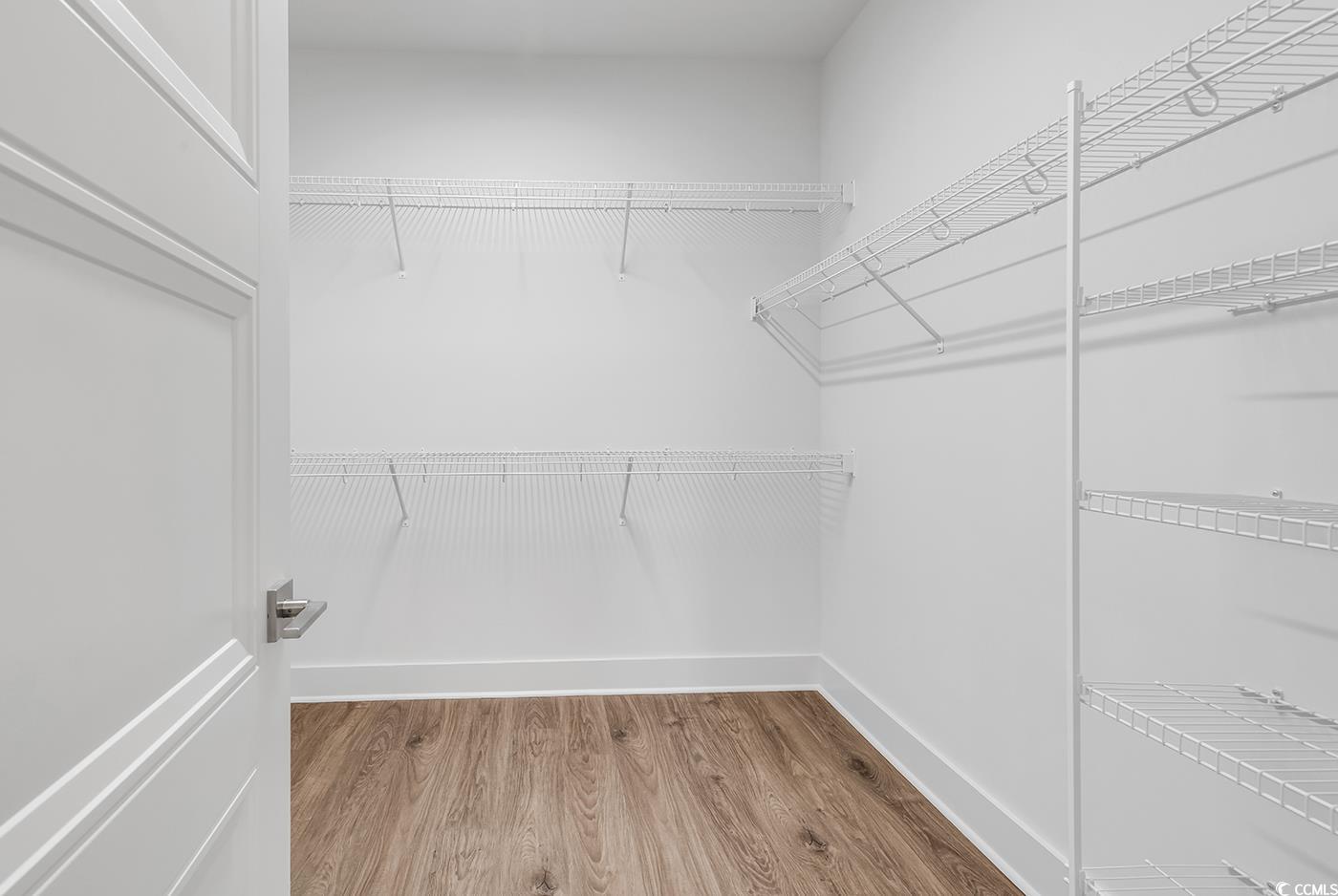 718 Highway 348 Loris, SC 29569 - Photo 22 of 28 Walk-in closet with wood laminate flooring