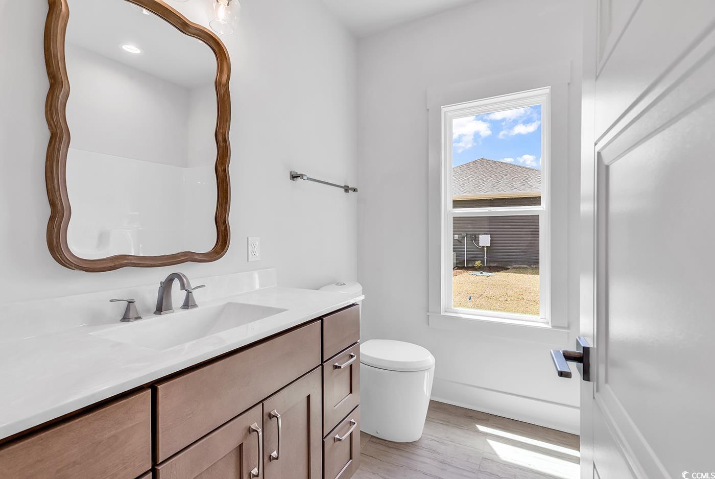 718 Highway 348 Loris, SC 29569 - Photo 25 of 28 Main Bathroom with tile flooring, and vanity with decorative wood mirror