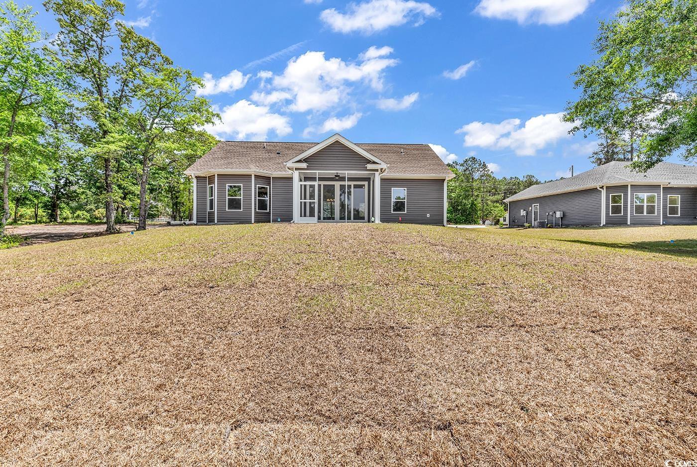 718 Highway 348 Loris, SC 29569 - Photo 5 of 28 Rear view of house featuring a yard, screened porch and patio