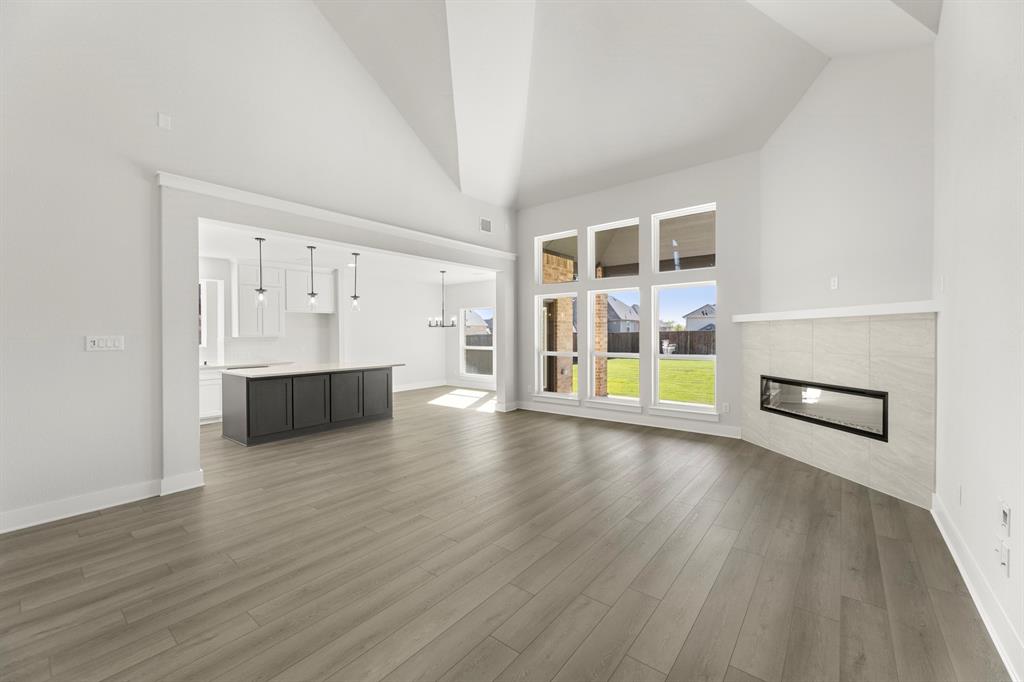 1285 Flamingo Road Forney, TX 75126 - Photo 13 of 40 an empty room with wooden floor and windows