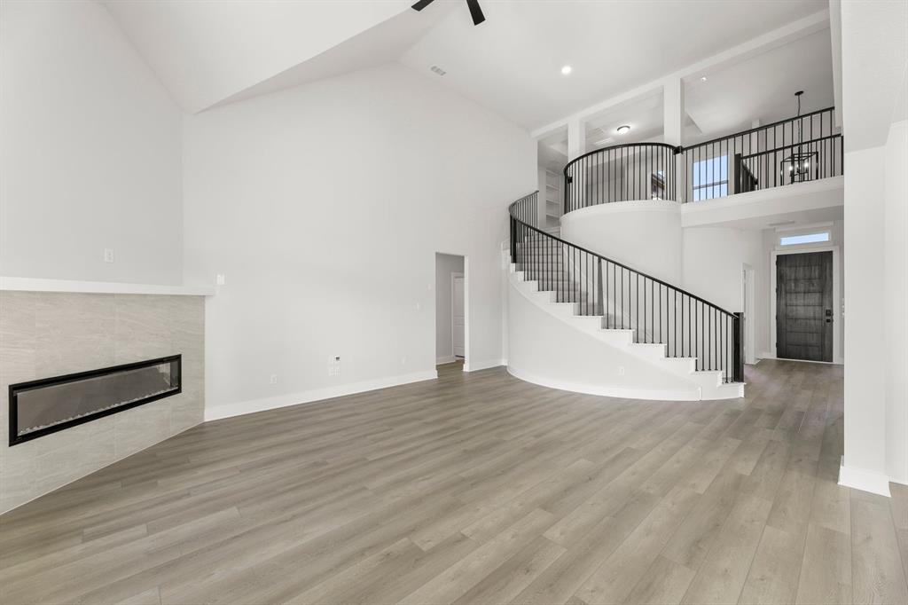 1285 Flamingo Road Forney, TX 75126 - Photo 16 of 40 a view of staircase and kitchen with wooden floor