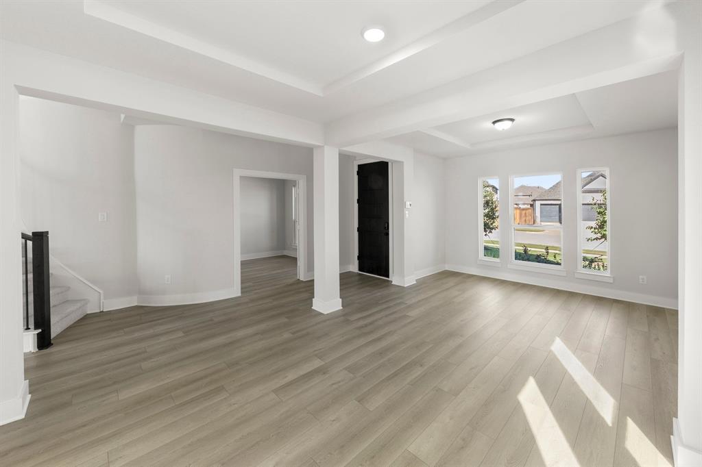 1285 Flamingo Road Forney, TX 75126 - Photo 17 of 40 an empty room with wooden floor and windows