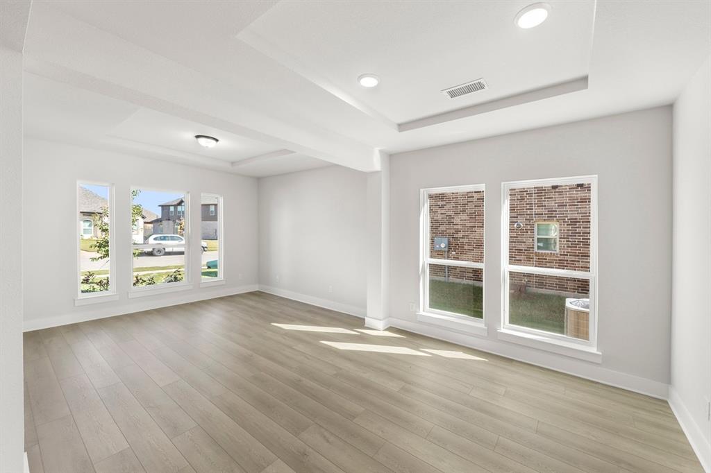 1285 Flamingo Road Forney, TX 75126 - Photo 20 of 40 a view of an empty room with a window and wooden floor