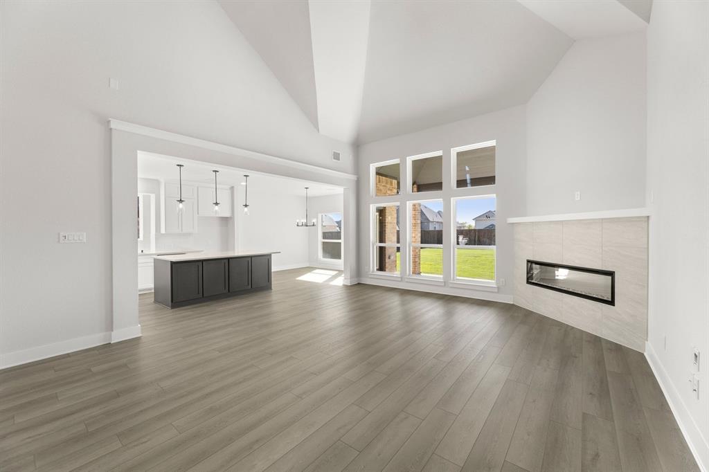 1285 Flamingo Road Forney, TX 75126 - Photo 21 of 40 an empty room with wooden floor and windows