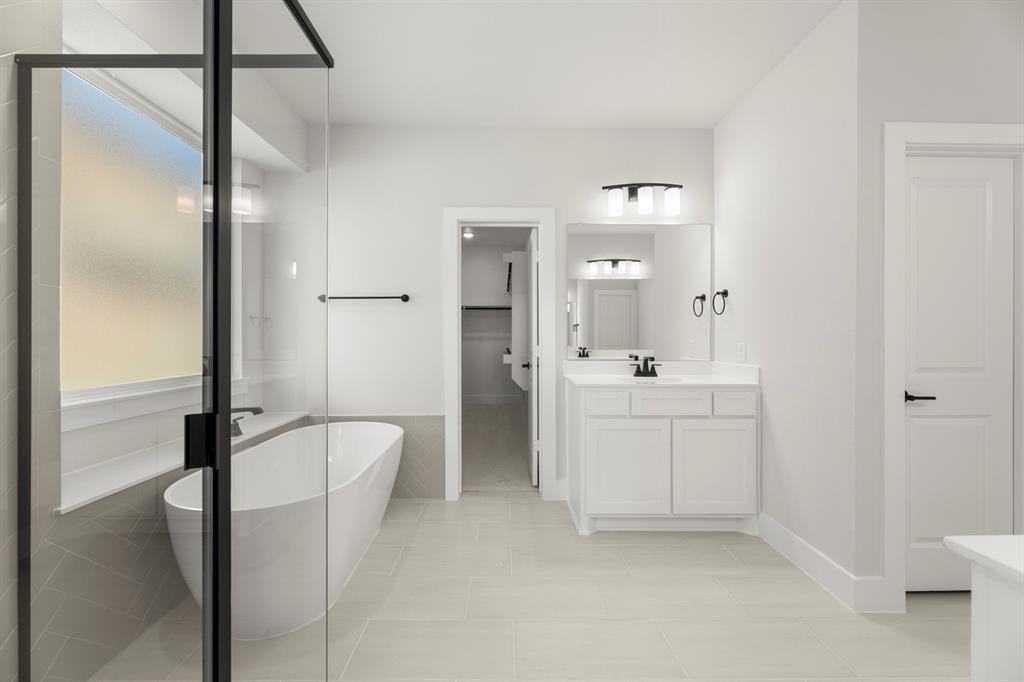 1285 Flamingo Road Forney, TX 75126 - Photo 28 of 40 a bathroom with a double vanity sink a mirror and a shower