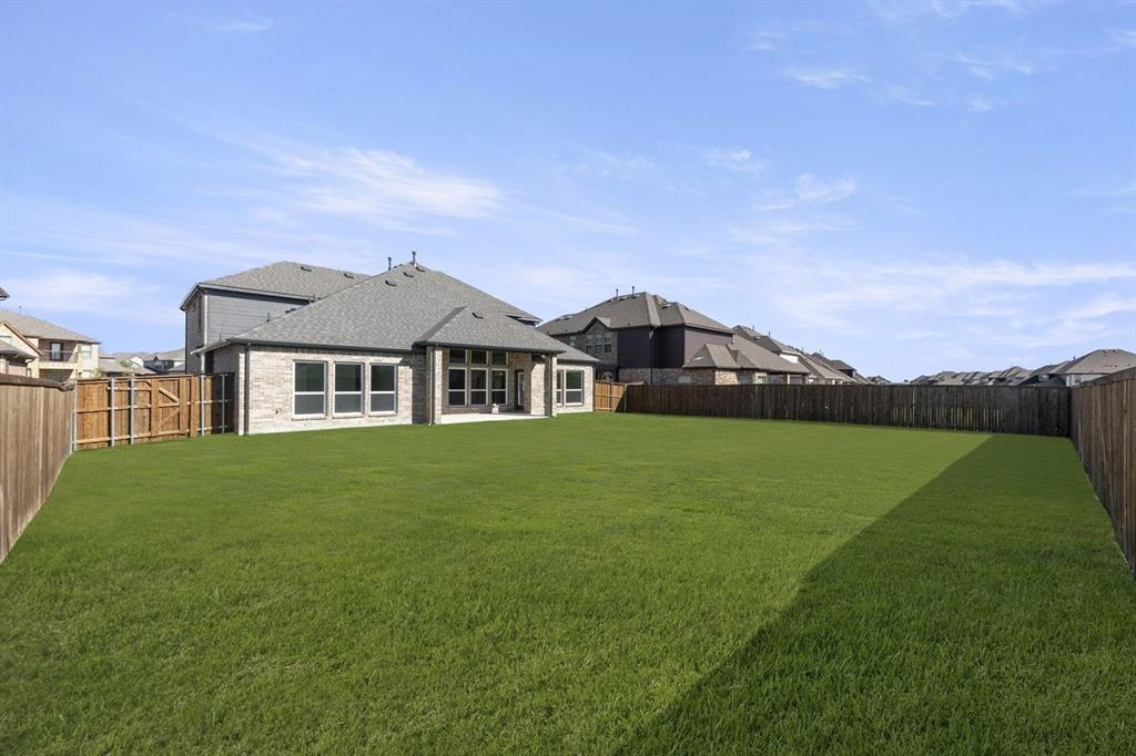 1285 Flamingo Road Forney, TX 75126 - Photo 37 of 40 a front view of a house with a garden and yard