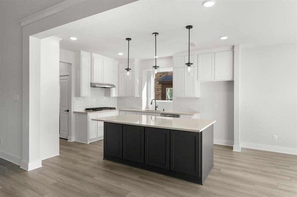 1285 Flamingo Road Forney, TX 75126 - Photo 4 of 40 a kitchen with kitchen island a sink stainless steel appliances and cabinets