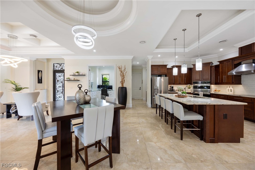 214 9th Street Northwest Naples, FL 34120 - Photo 13 of 49 a large kitchen with a table and chairs