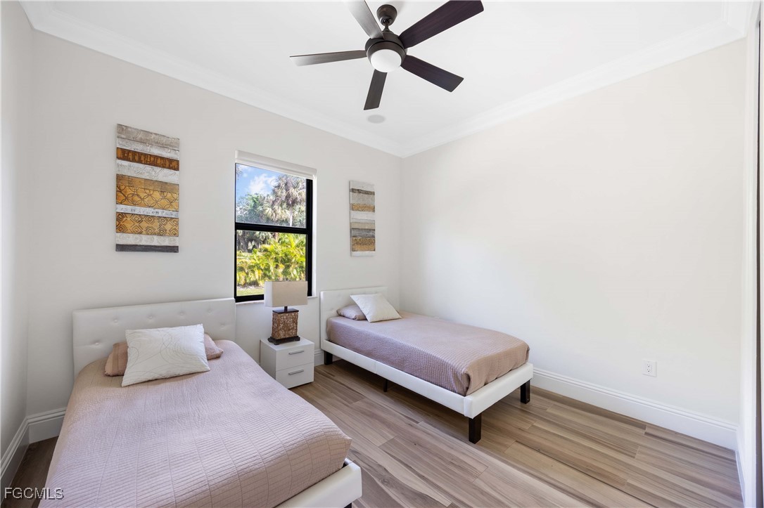 214 9th Street Northwest Naples, FL 34120 - Photo 32 of 49 a bedroom with two beds and a window