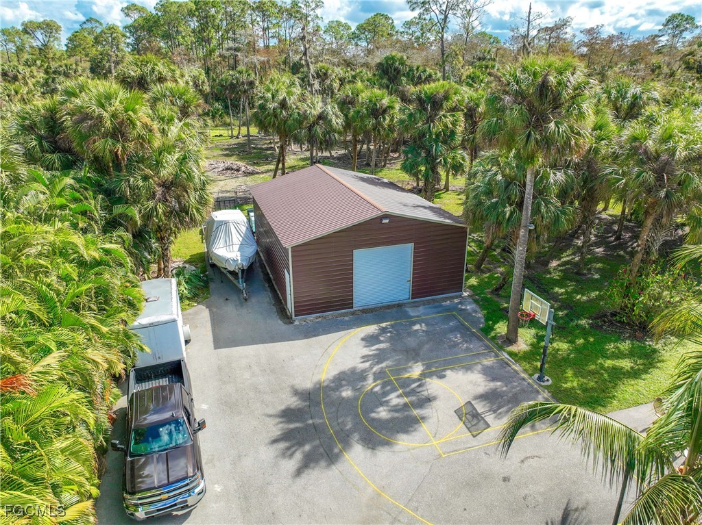 214 9th Street Northwest Naples, FL 34120 - Photo 43 of 49 a house with trees in front of it