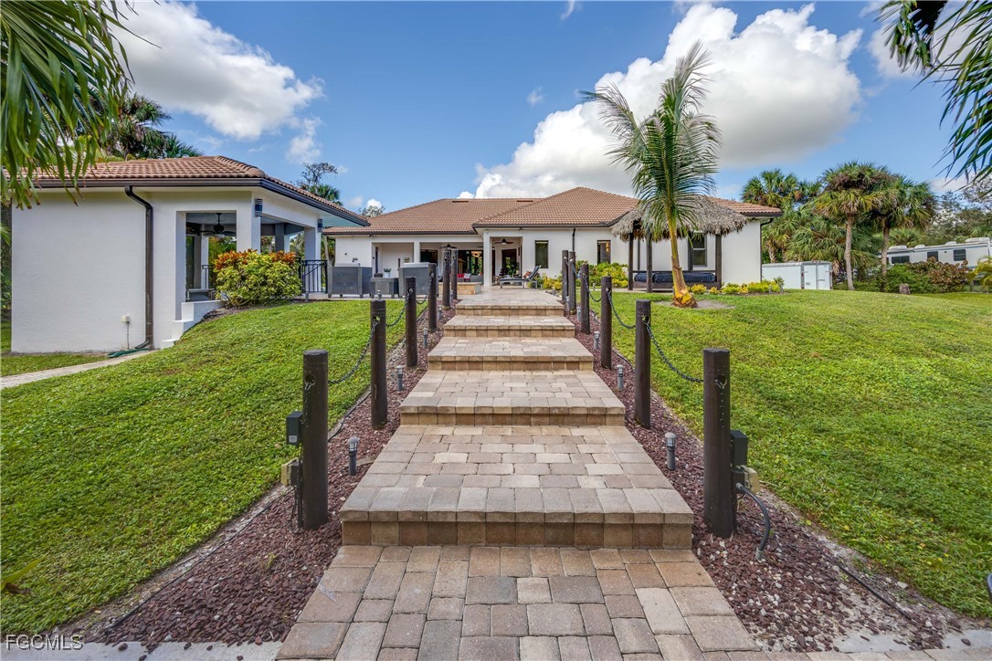 214 9th Street Northwest Naples, FL 34120 - Photo 44 of 49 a front view of a house with a yard