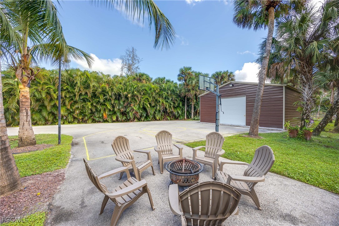 214 9th Street Northwest Naples, FL 34120 - Photo 45 of 49 a backyard of a house with table and chairs