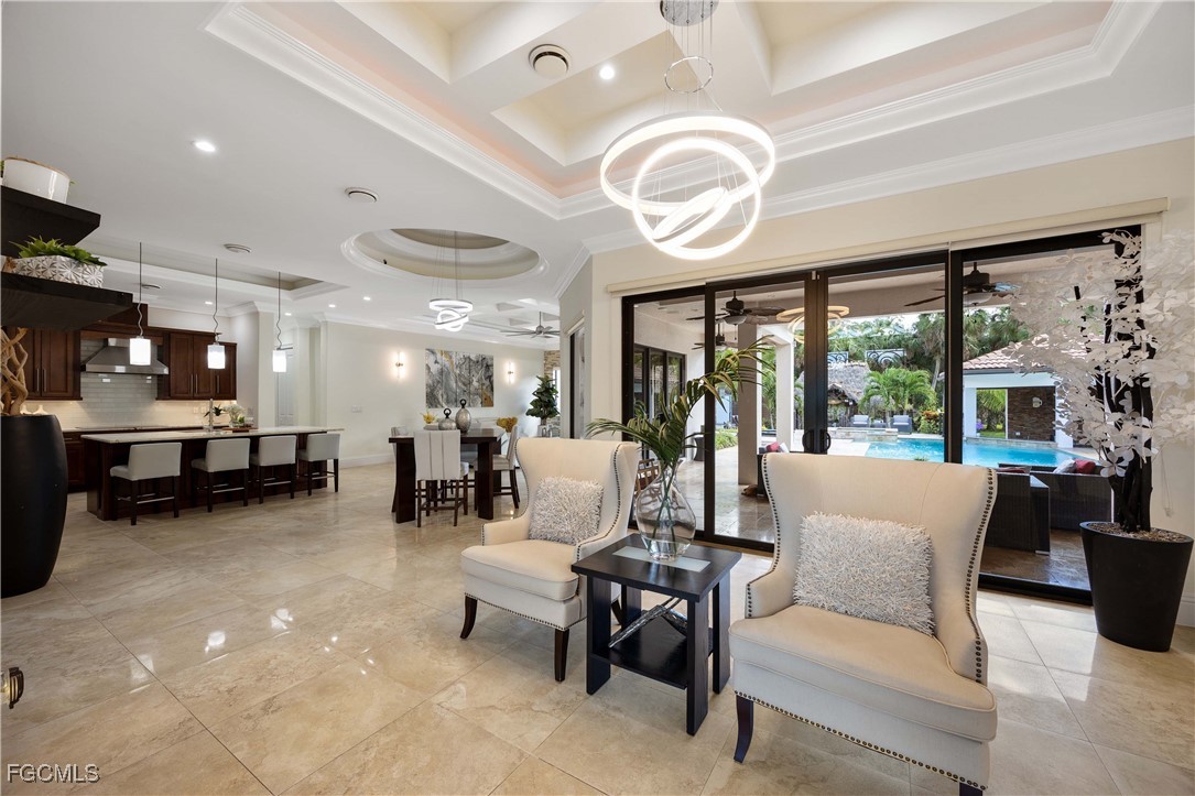 214 9th Street Northwest Naples, FL 34120 - Photo 9 of 49 a living room with furniture a fireplace and a large window