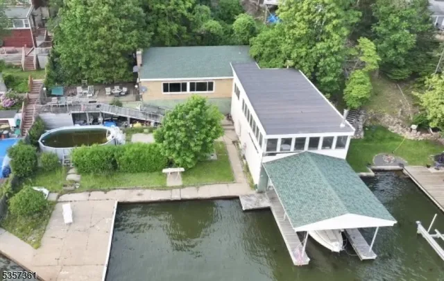 an aerial view of a house with swimming pool table and chairs