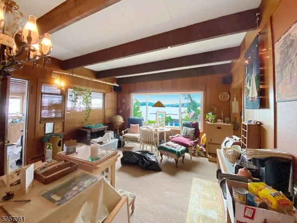 a living room with furniture a lamp and a potted plant
