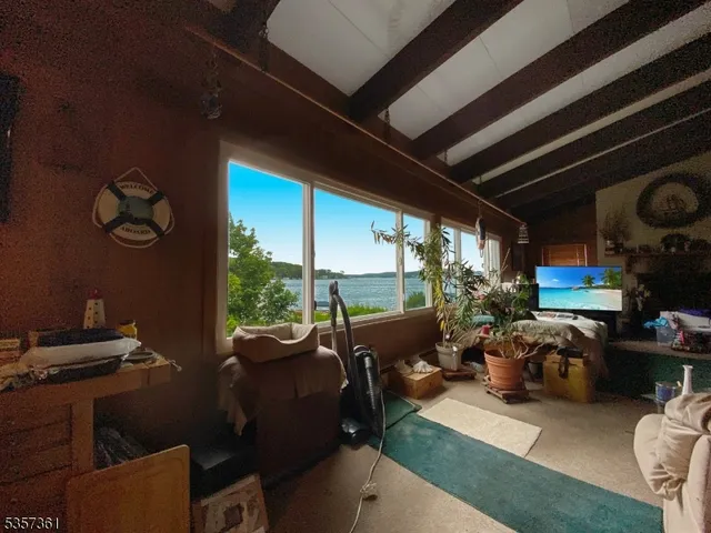 a living room with furniture a fireplace and a window