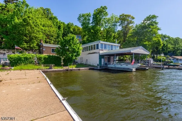 a front view of a house with swimming pool and porch