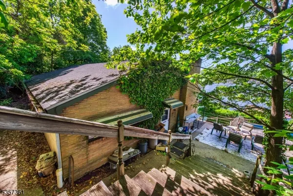 a view of a swimming pool with a patio and a yard