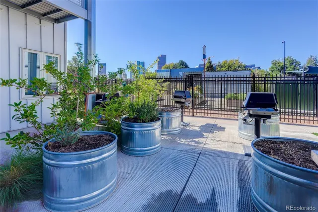a view of a porch with chairs and potted plants