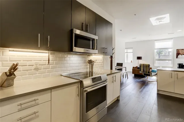 a kitchen with stainless steel appliances kitchen island granite countertop a stove and a sink