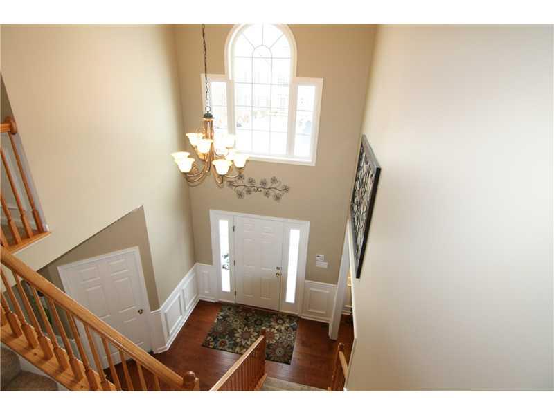 Entry/Foyer. Setting a tone of welcome! Two-story entry with hardwood flooring, chair rail, wainscoting...The Palladium window and door sidelight allow plenty of natural light!