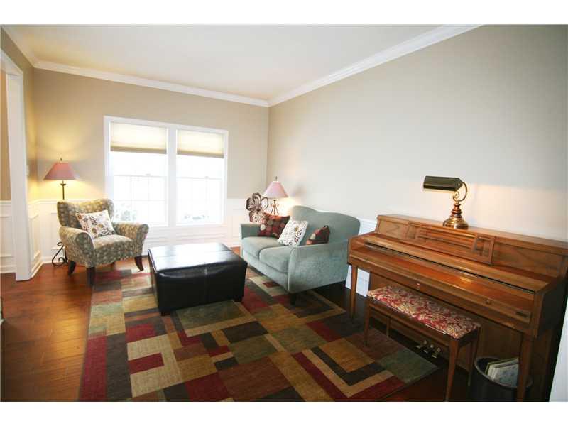 Living Room. A pleasant escape!  Hardwood flooring, crown molding, chair rail and wainscoting...Long windows provide extra natural light...