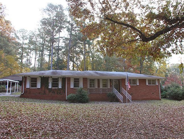 6700 Johnsdale Road Raleigh, NC 27615 - Photo 1 of 14 a view of a house with a backyard