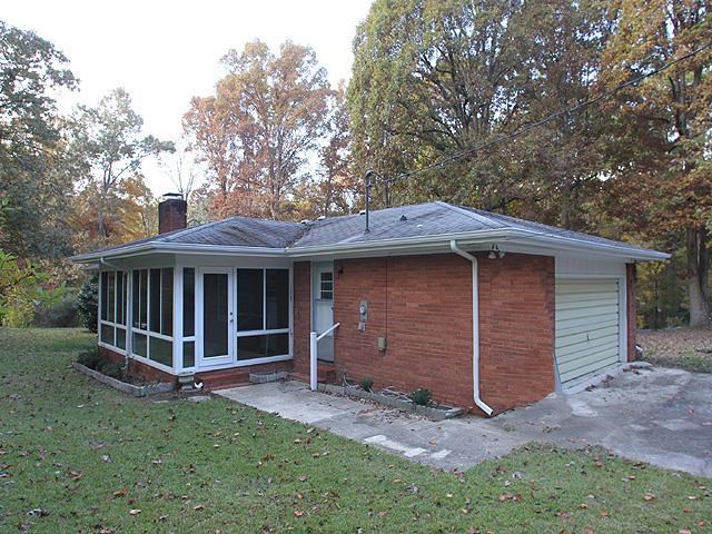 6700 Johnsdale Road Raleigh, NC 27615 - Photo 12 of 14 a view of a house with a yard and large tree