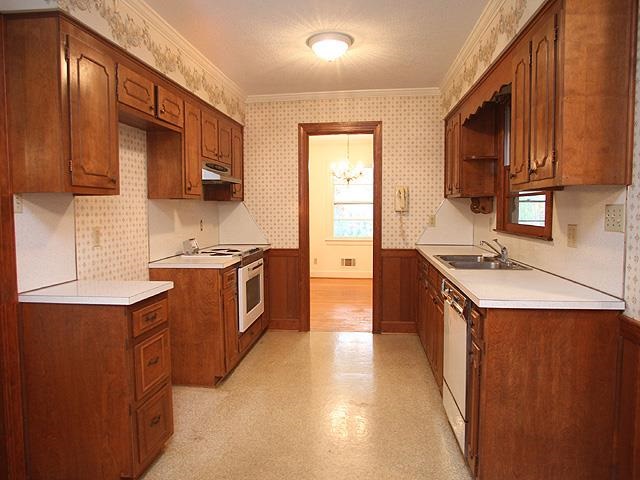 6700 Johnsdale Road Raleigh, NC 27615 - Photo 4 of 14 a kitchen with stainless steel appliances granite countertop a stove a sink and a microwave