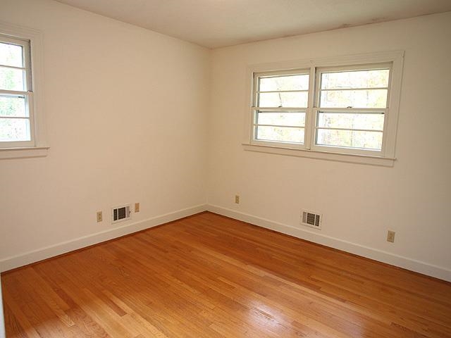 6700 Johnsdale Road Raleigh, NC 27615 - Photo 9 of 14 an empty room with wooden floor and windows