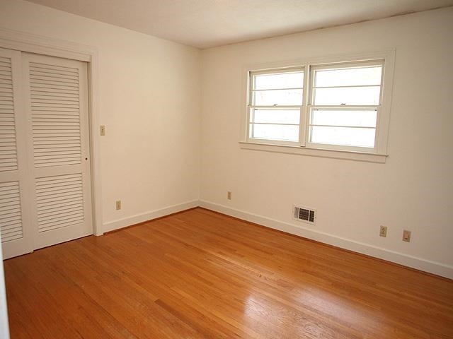 6700 Johnsdale Road Raleigh, NC 27615 - Photo 10 of 14 an empty room with wooden floor and windows