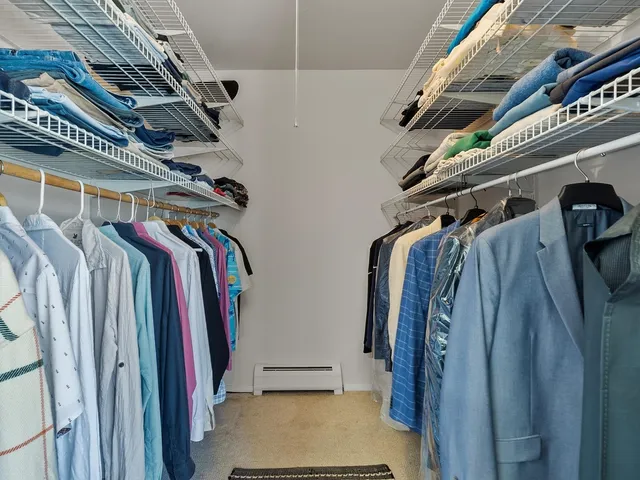 a view of walk in closet with clothes and shoes