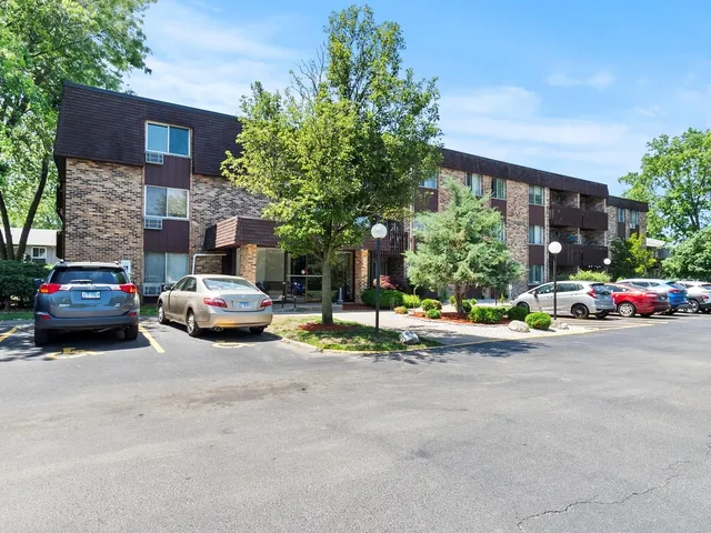 a view of a car parked in front of a brick house